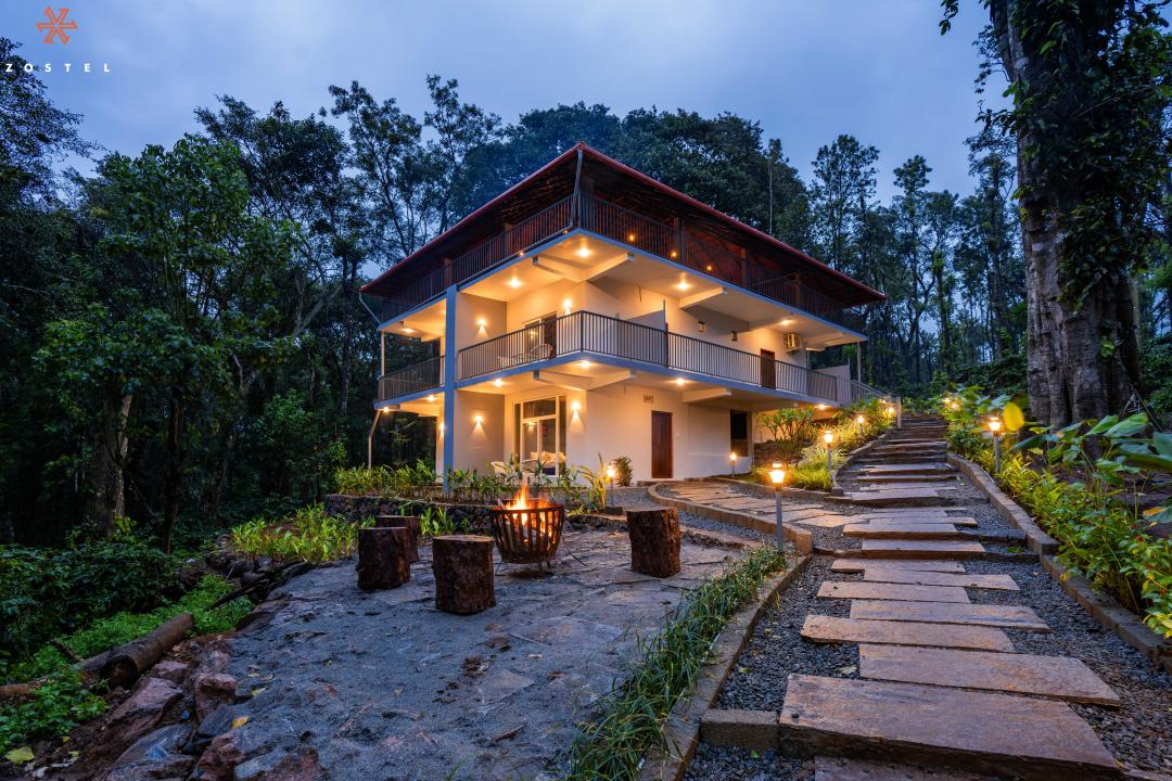 Concealed within a lush expanse of delicate coffee plants, pepper creepers, and shrouded jackfruit trees lies Zostel Coorg (Madikeri). Dipped in tranquillity, this traditional Kannada hostel is meant for interacting with nature and spending time with friends. 